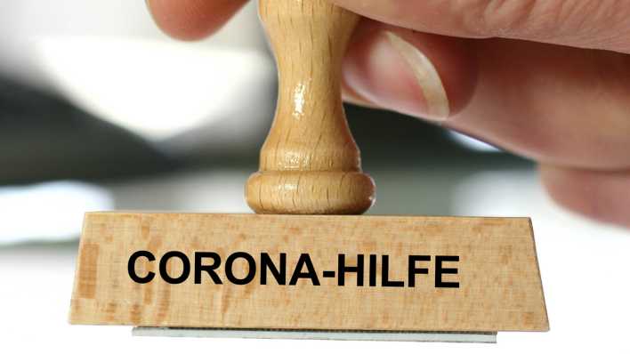 Holzstempel, Aufschrift: Corona-Hilfe