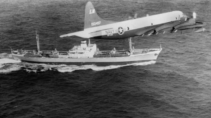 ARCHIV: Ein Aufklärungsflugzeug der US-Marine fliegt am 10.11.1962 vor der Küste Costa Ricas über das US-Kriegsschiff USS-Barry (vorne) und den sowjetische Frachter Anosow.