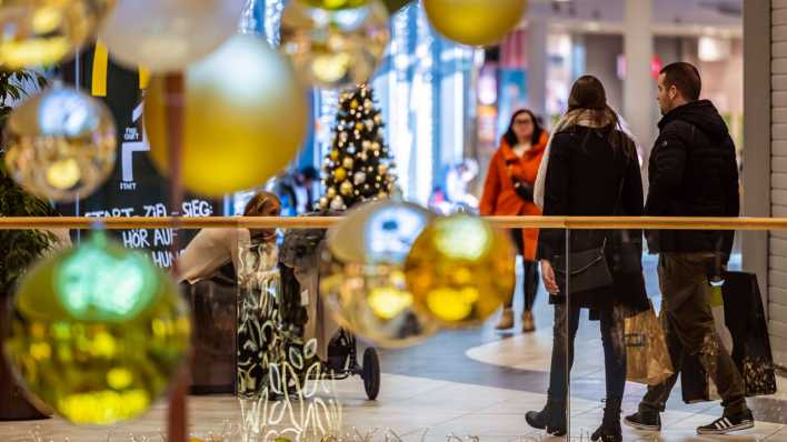 Weihnachtseinkauf unter festlicher Dekoration in einem Einkaufszentrum