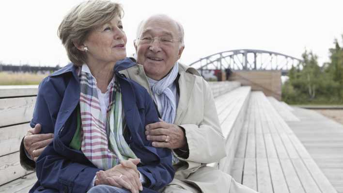 Seniorenpaar sitzt auf einer Bank