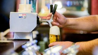 Ein Kneipenwirt zapft in einer Berliner Gaststätte Bier (Bild: dpa / Christoph Soeder)