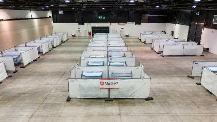Stockbetten stehen zwischen Zäunen in einer Notunterkunft für Asylsuchende in der Messe Offenburg (Bild: dpa / Philipp von Ditfurth)