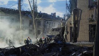 Rettungskräfte suchen am Donnerstag in einem Wohngebiet in Kiew nach Überlebenden eines russischen Raketenangriffs.