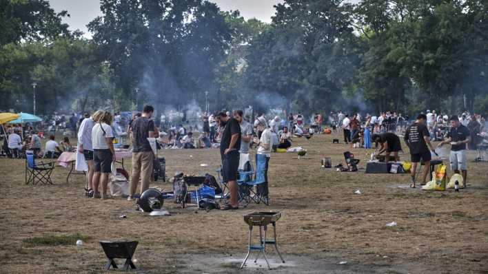 Menschen grillen auf einer Wiese im Volkspark Friedrichshain.