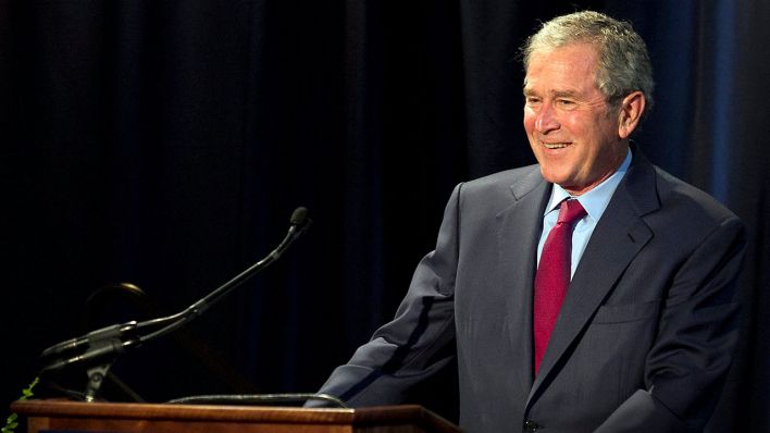 Former US President George W. Bush reacts as he speaks during the Civil Rights Summit at the LBJ Presidential Library