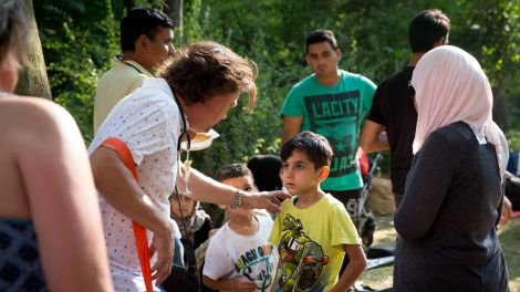 Freiwillige Helfer untersuchen vor dem Berliner Landesamt für Gesundheit und Soziales (LaGeSo) in Moabit Flüchtlinge und behandeln kleinere Verletzungen. (Foto: imago / Christian Mang)